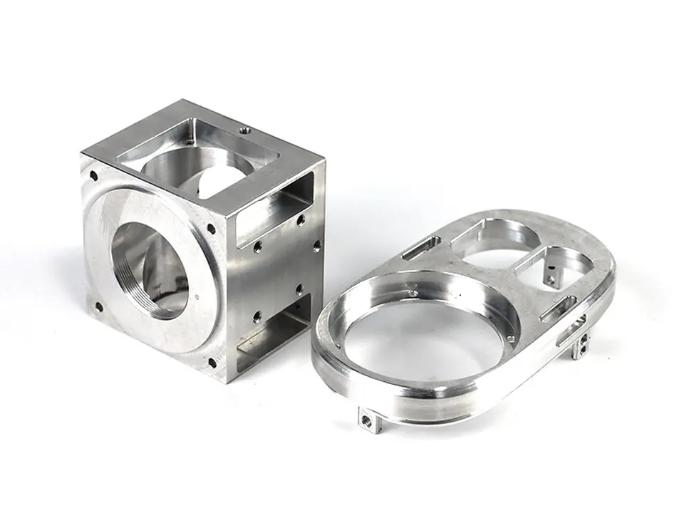Aluminium block with threaded bore and an oval aluminium bracket, machined from billet