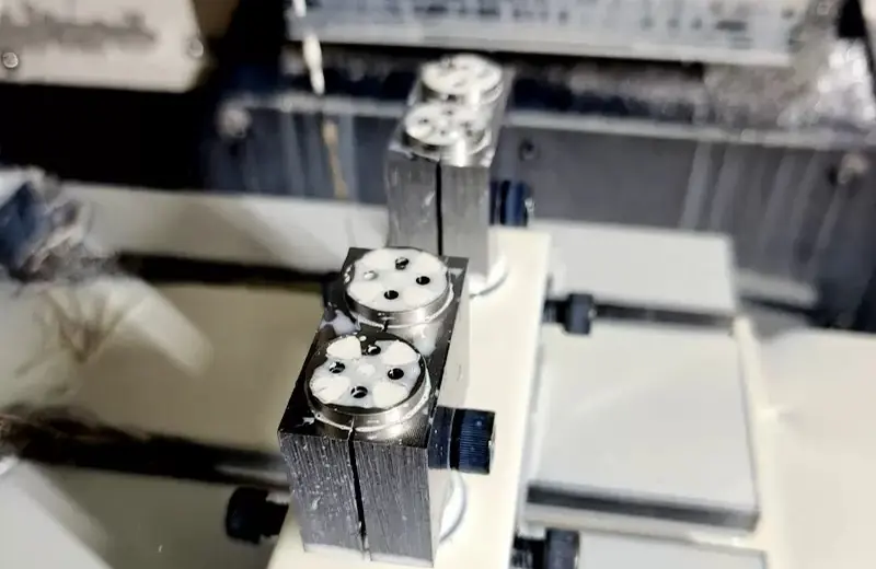 Small turned parts held in a multi-station fixture on a machining centre