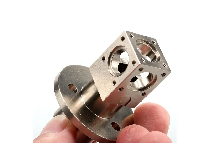 Machined stainless steel housing with counterbored ports and tapped holes