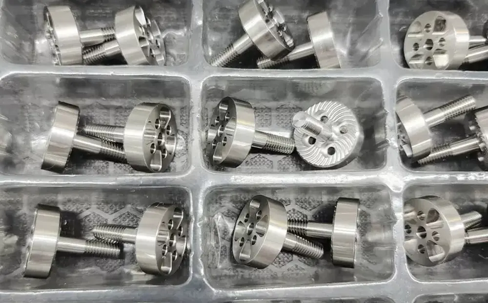 Finished stainless steel turned and milled parts, individually packed in a tray